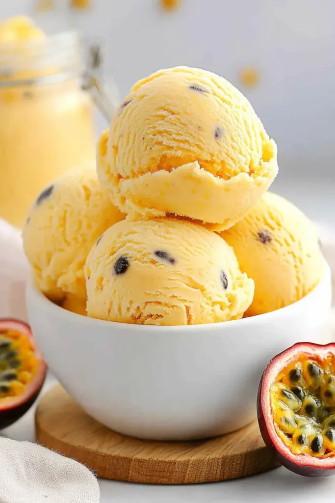 Bowl of passion fruit ice cream scoops with fresh passion fruit
