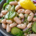 Dill pickle white bean salad served with greens