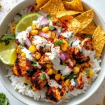 street corn chicken rice bowl with grilled chicken, elote corn, rice, lime, and cilantro